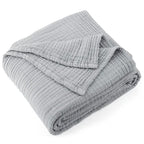 Folded light gray 100% cotton muslin throw