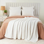 White cotton muslin blanket layered on a bed