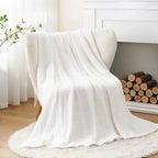 White cotton muslin throw on an armchair by a fireplace