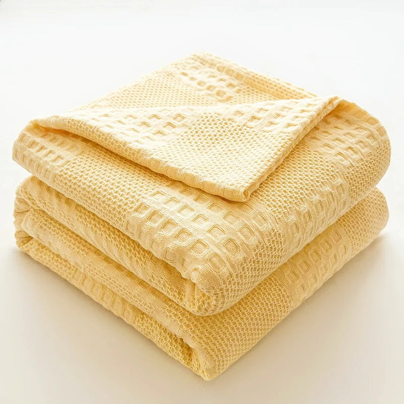 Folded butter yellow 100% cotton waffle weave blanket