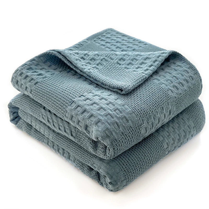 Folded dusty blue 100% cotton waffle weave blanket