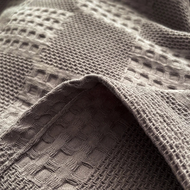 Close-up of charcoal gray cotton waffle weave texture