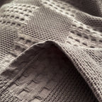 Close-up of charcoal gray cotton waffle weave texture