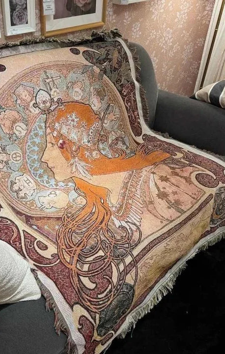 Art Nouveau woven tapestry throw blanket draped over a sofa