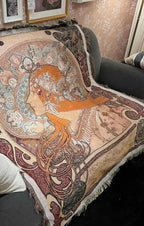 Art Nouveau woven tapestry throw blanket draped over a sofa