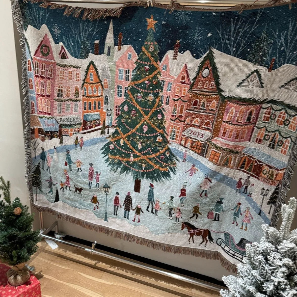 Winter Village woven Christmas tapestry hanging on a wall