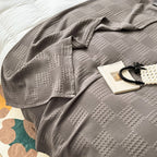 Charcoal gray cotton waffle weave blanket with a book