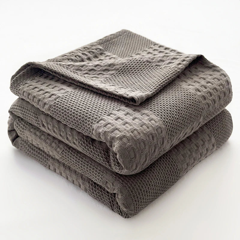 Folded charcoal gray 100% cotton waffle weave blanket